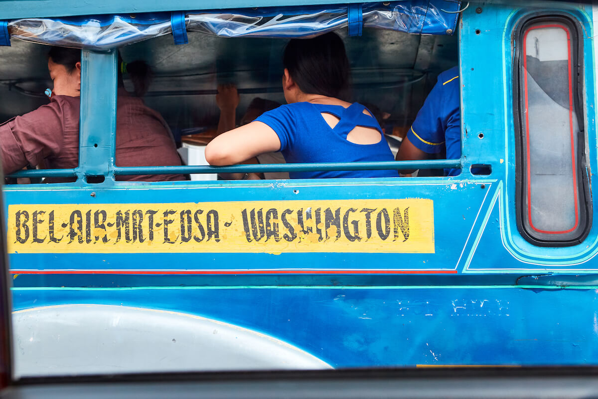 People sitting in a blue jeepney