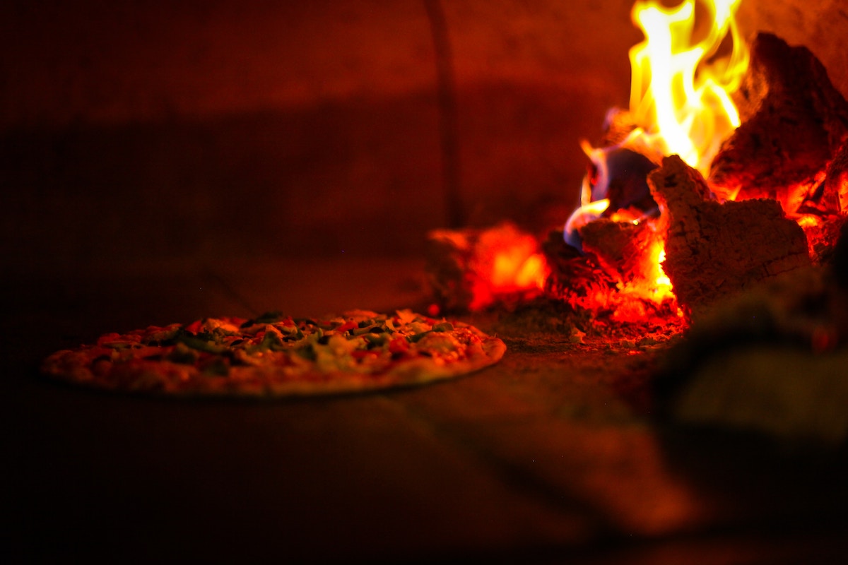 Pizza baking in a brick oven