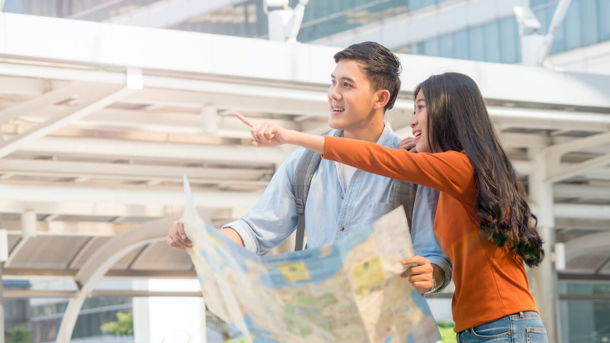 Travelling couple looking at a map