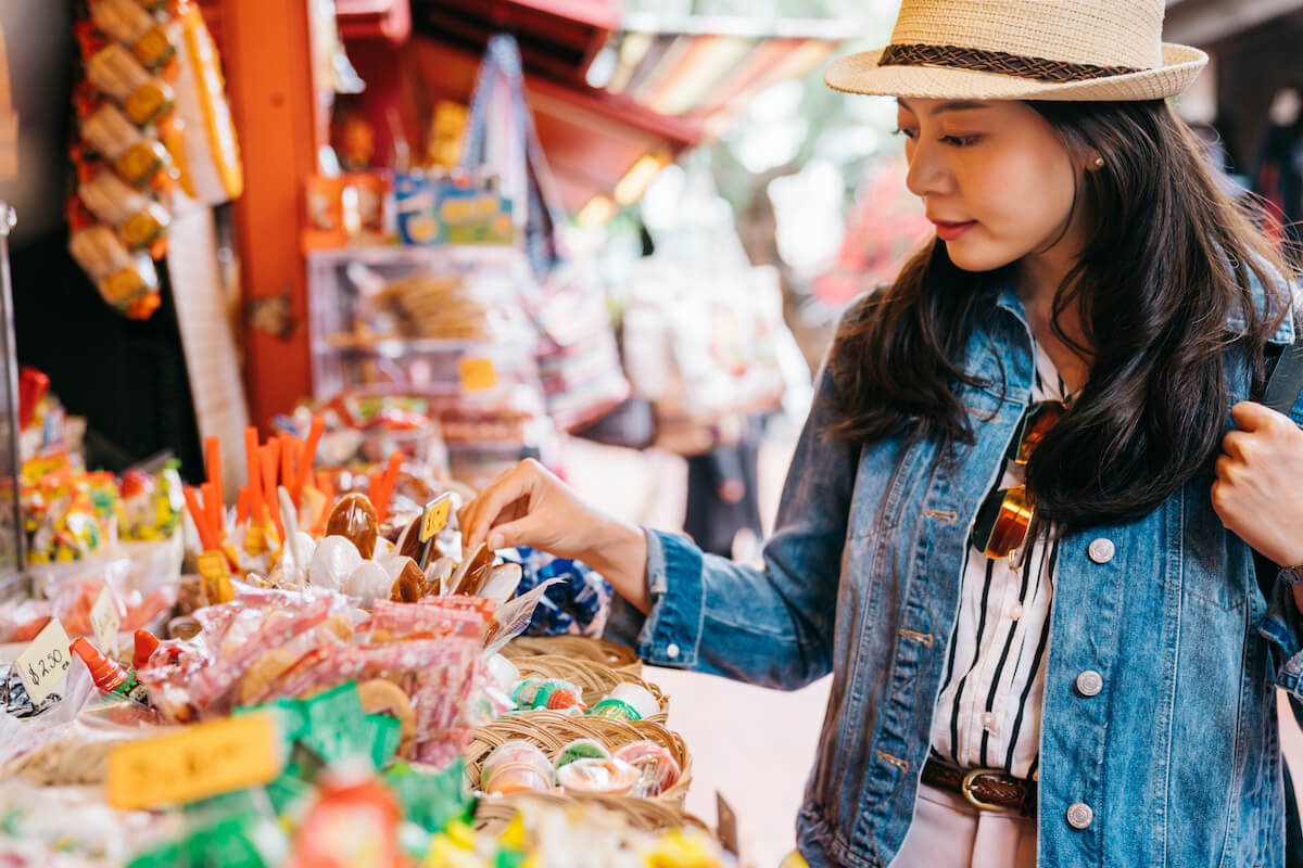 Woman selecting sweets on a street