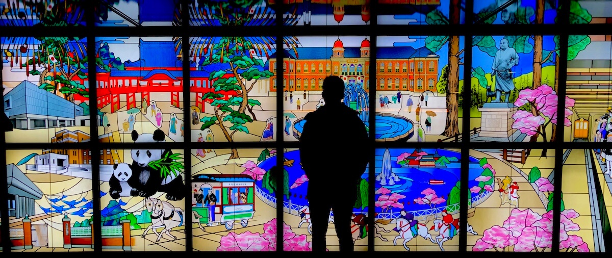 Man posing in front of stained glass