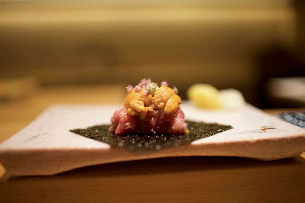 Ground tuna and sea urchin sushi on seaweed