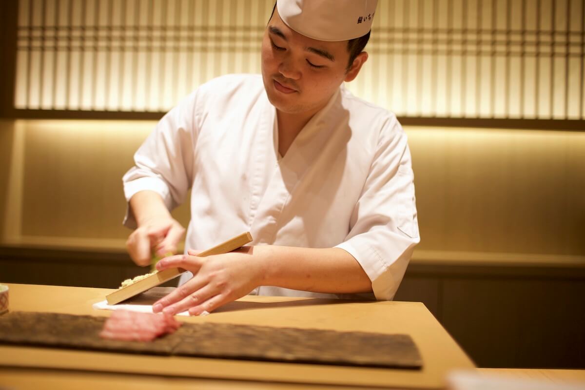 Sushi chef grinds fresh wasabi