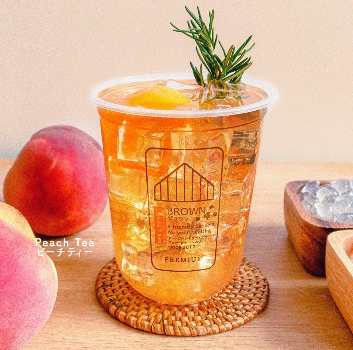 photo of peach tea inside brown cafe in serendra bgc